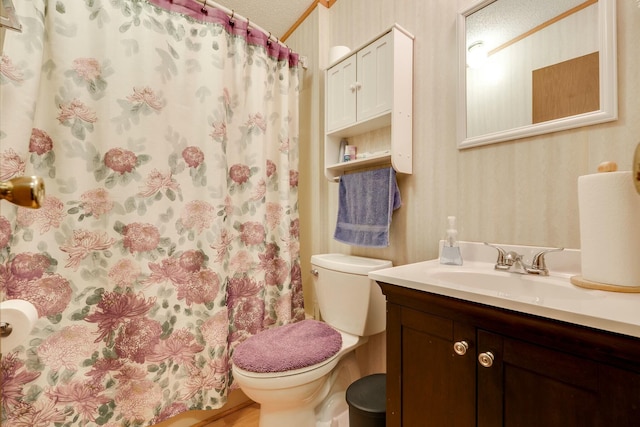 bathroom featuring wallpapered walls, toilet, curtained shower, a textured ceiling, and vanity