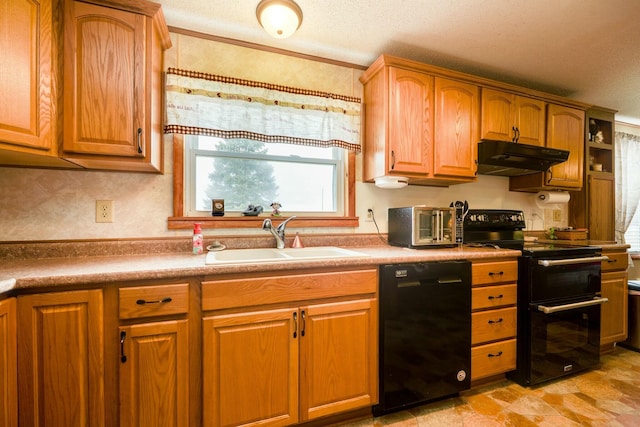 kitchen with a textured ceiling, under cabinet range hood, a sink, brown cabinets, and black appliances