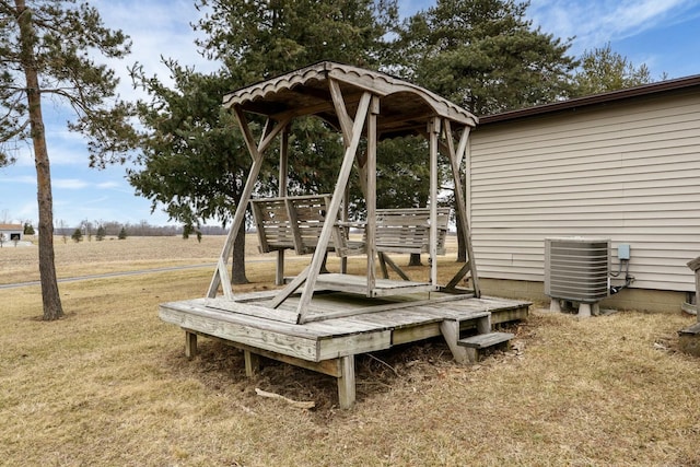 view of playground with a lawn and central air condition unit