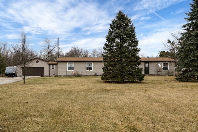 exterior space featuring driveway, a front lawn, and an attached garage