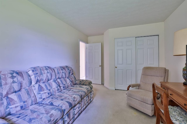living area featuring baseboards and light colored carpet