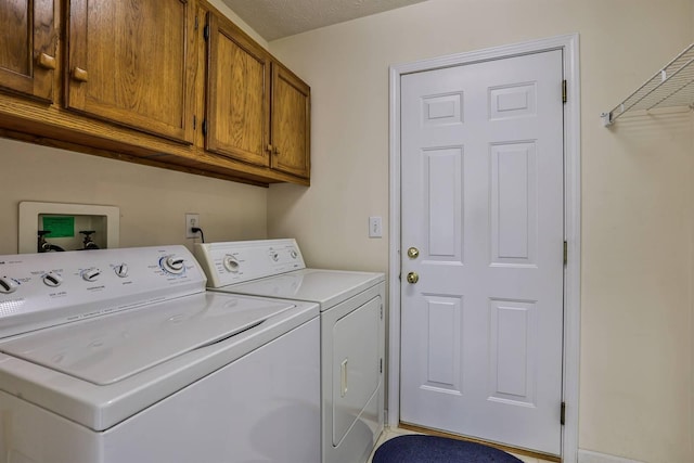 laundry room featuring cabinet space and separate washer and dryer