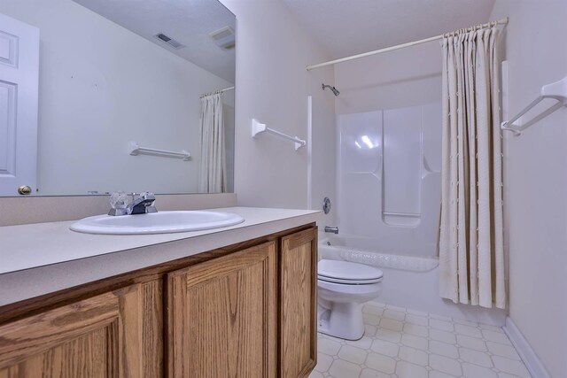 full bathroom featuring vanity, toilet, tile patterned floors, shower / bath combo with shower curtain, and visible vents