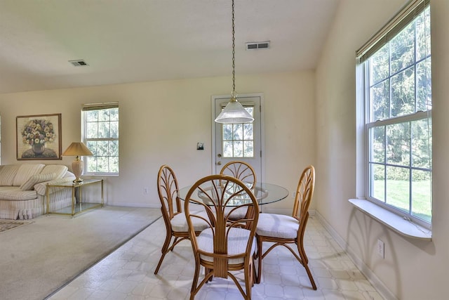 dining area with baseboards, light carpet, and visible vents