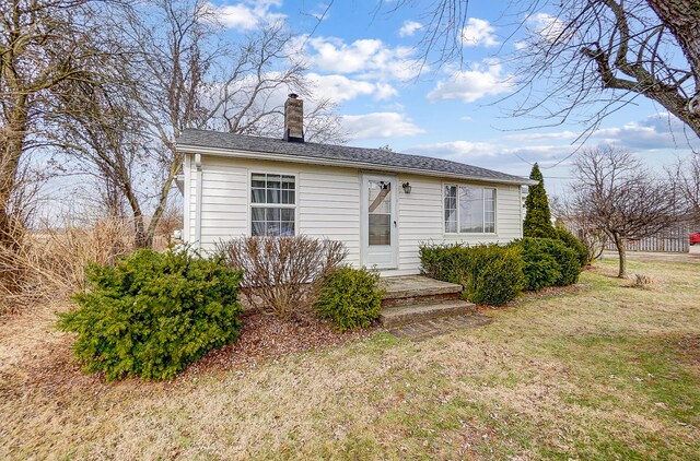 back of house featuring a wooden deck and a yard