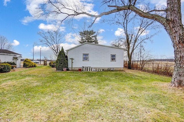 view of side of home with a lawn