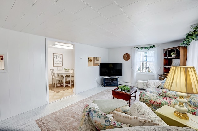 living room with a baseboard radiator and light wood-type flooring