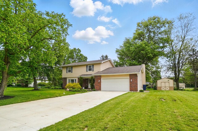 2357 London Dr, Lima, OH 45805 - view of front of house with a garage, a front yard, brick siding, and concrete driveway