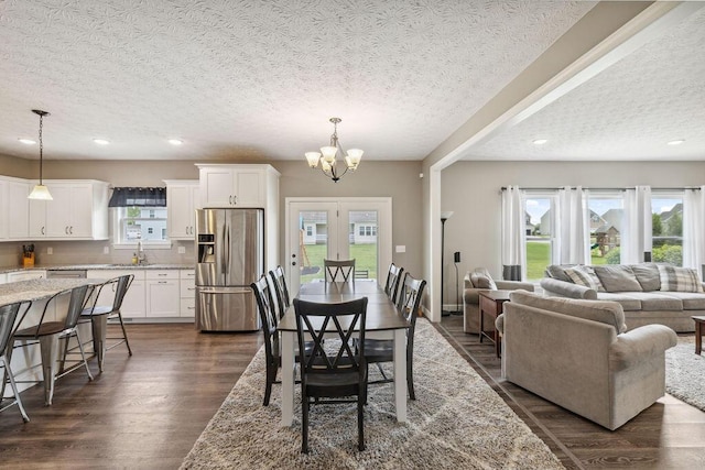 2306 Larkspur Dr, Troy, OH 45373 - dining room with a textured ceiling, dark wood-style flooring, a chandelier, and recessed lighting