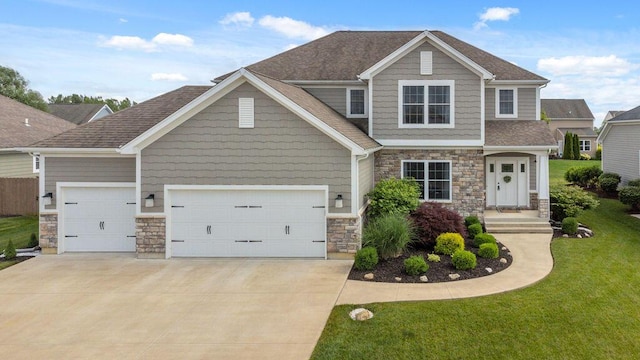 2306 Larkspur Dr, Troy, OH 45373 - craftsman-style home with stone siding, an attached garage, concrete driveway, a front yard, and roof with shingles