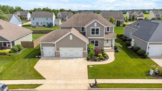2306 Larkspur Dr, Troy, OH 45373 - view of front facade with a residential view, stone siding, driveway, and an attached garage