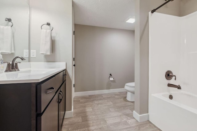 2306 Larkspur Dr, Troy, OH 45373 - bathroom with vanity, washtub / shower combination, wood finished floors, and a textured ceiling