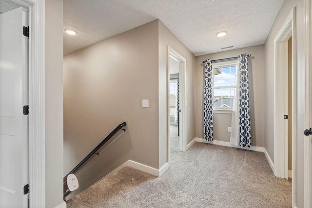 2306 Larkspur Dr, Troy, OH 45373 - corridor with an upstairs landing, carpet floors, and a textured ceiling