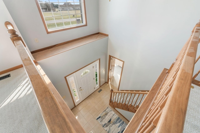 entryway with tile patterned flooring, visible vents, and baseboards