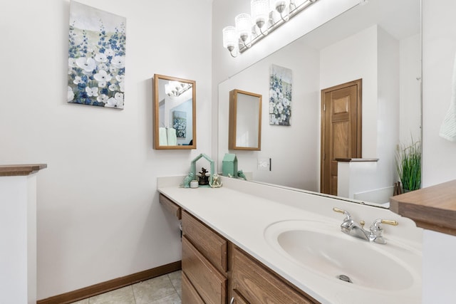 bathroom with tile patterned flooring, vanity, and baseboards