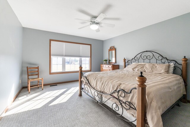 bedroom featuring visible vents, carpet floors, baseboards, and ceiling fan