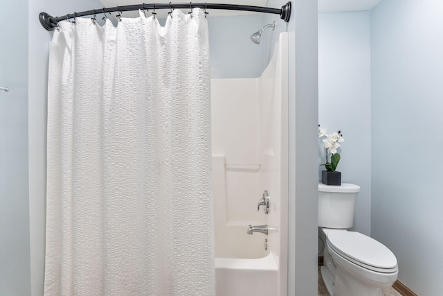 bathroom featuring toilet and shower / tub combo with curtain