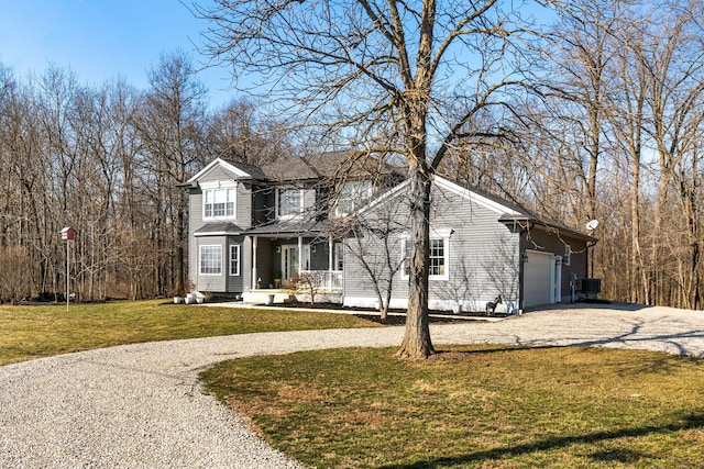 traditional-style home with driveway, an attached garage, and a front lawn