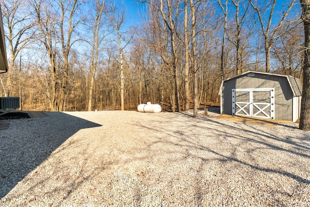 view of yard with a storage unit, central AC, and an outdoor structure