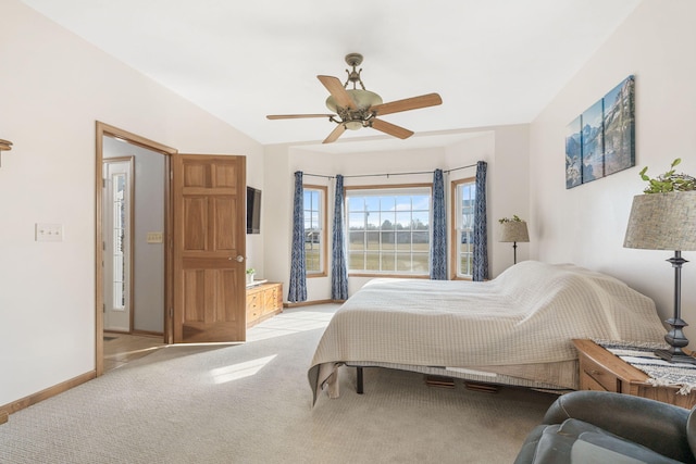 carpeted bedroom featuring baseboards, lofted ceiling, and a ceiling fan