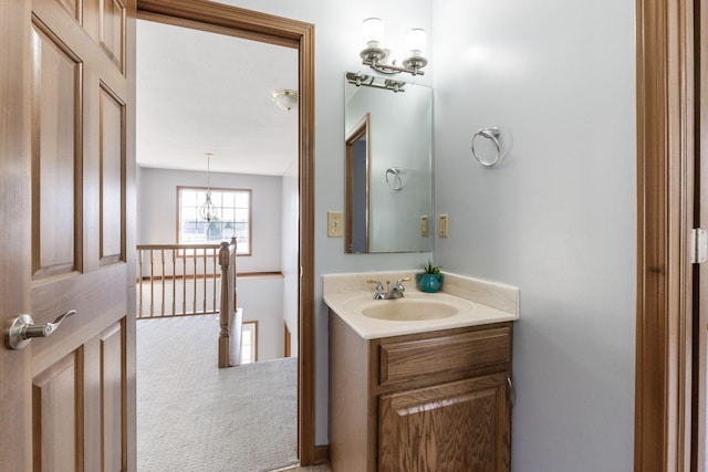 bathroom featuring vanity and a chandelier