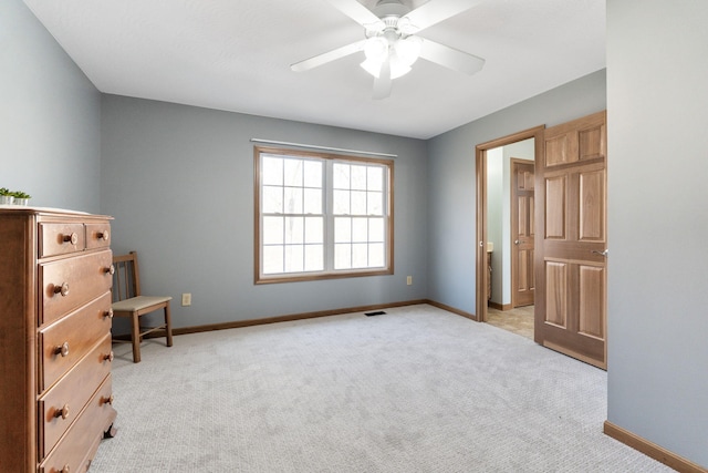 bedroom with visible vents, baseboards, light colored carpet, and ceiling fan