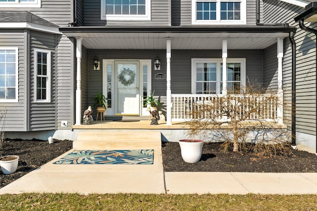 view of exterior entry featuring a porch