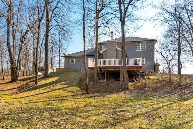 back of property featuring a deck and a yard