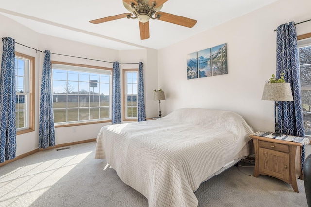 bedroom with a ceiling fan, baseboards, visible vents, and carpet floors