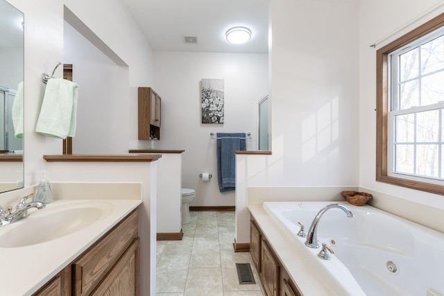 bathroom featuring toilet, a tub with jets, tile patterned flooring, baseboards, and vanity