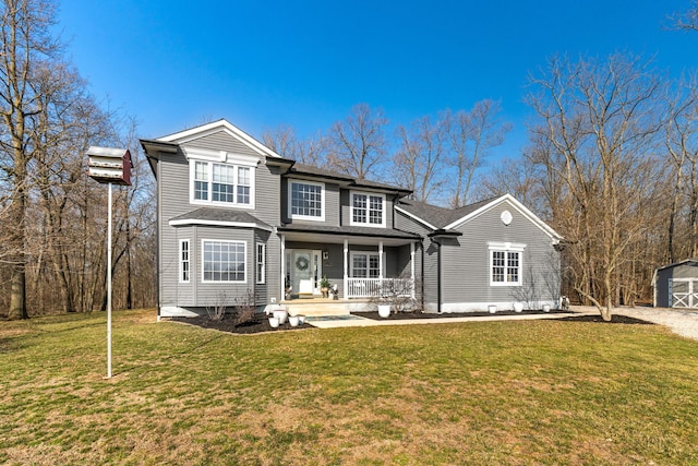 traditional-style home with a front yard, covered porch, and an outdoor structure