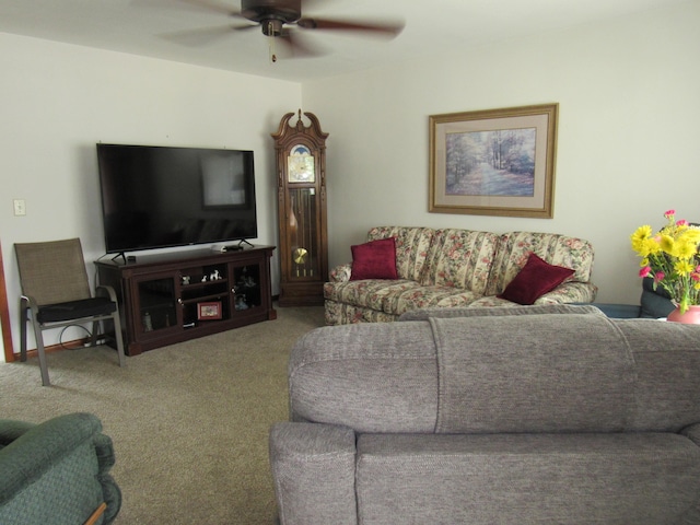 living area featuring a ceiling fan and carpet floors