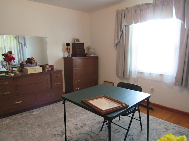 bedroom featuring light wood-type flooring and baseboards