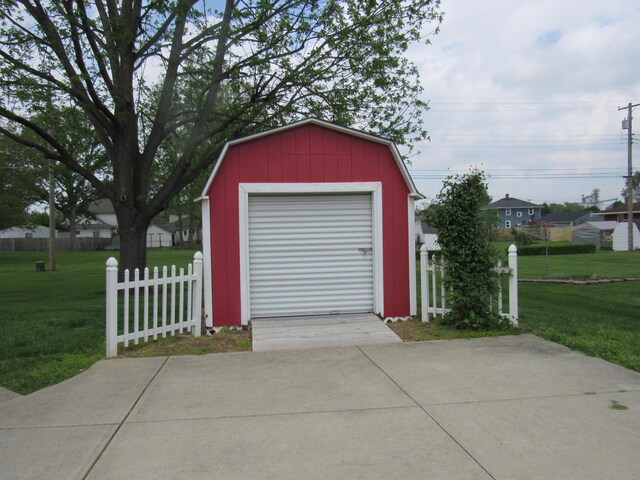 garage featuring concrete driveway