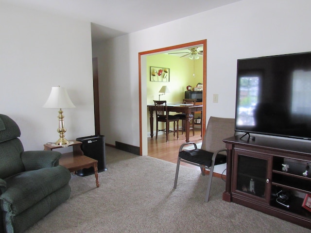 carpeted living room featuring a ceiling fan
