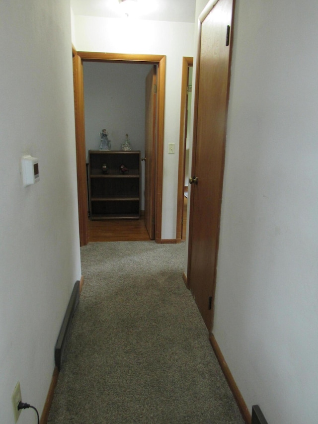 corridor featuring carpet floors and baseboards