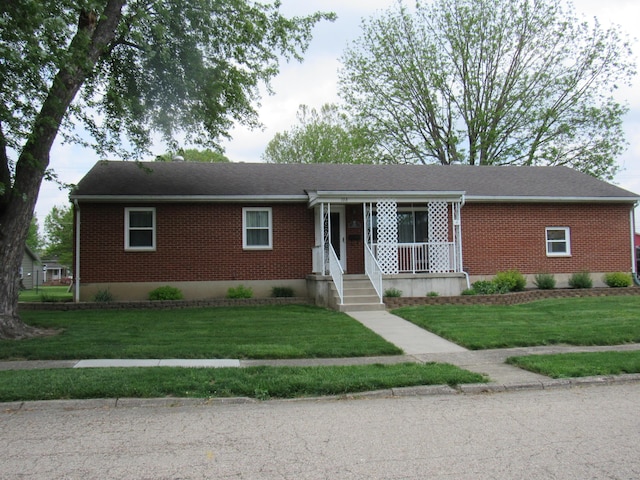 single story home with brick siding and a front yard