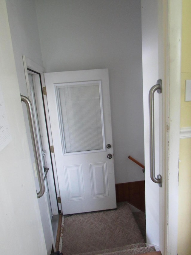 doorway featuring carpet flooring