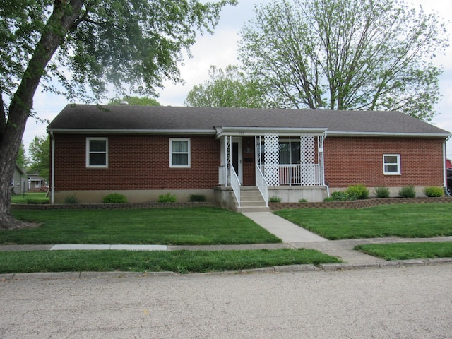 single story home featuring brick siding and a front lawn