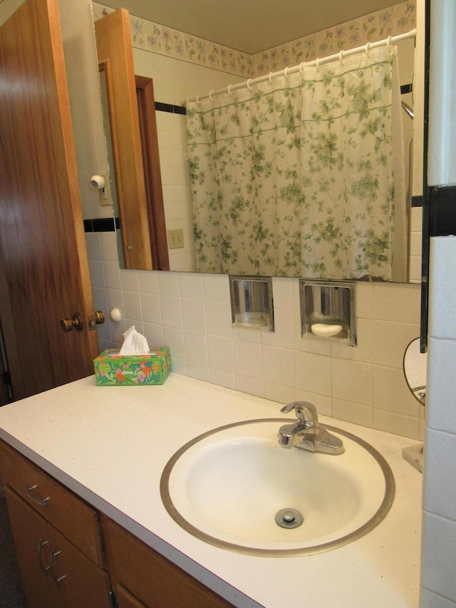 bathroom with vanity, curtained shower, and decorative backsplash