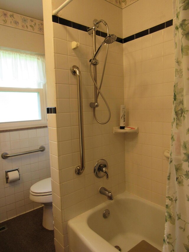 full bath with shower / bath combo with shower curtain and toilet