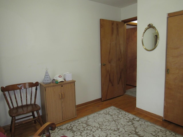 sitting room featuring wood finished floors and baseboards