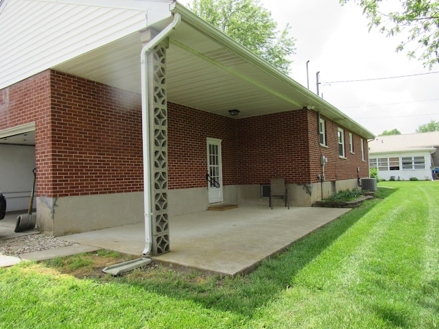 view of property exterior featuring a lawn, brick siding, a patio area, and cooling unit