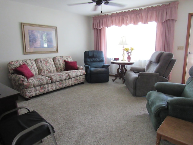 carpeted living area featuring ceiling fan