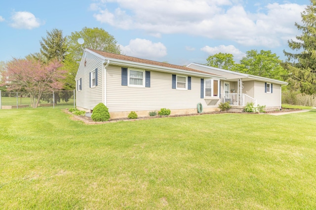 ranch-style home featuring fence and a front yard