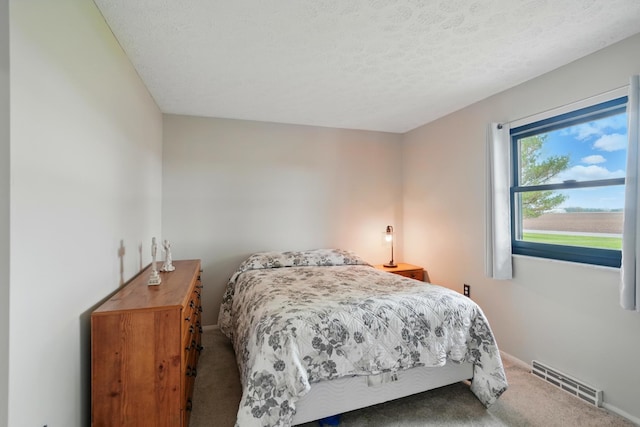 bedroom featuring carpet floors, baseboards, and visible vents