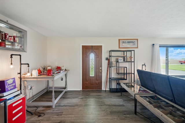 foyer featuring baseboards and wood finished floors