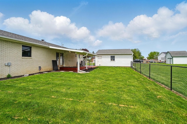 rear view of property featuring a fenced backyard, a patio, and a lawn