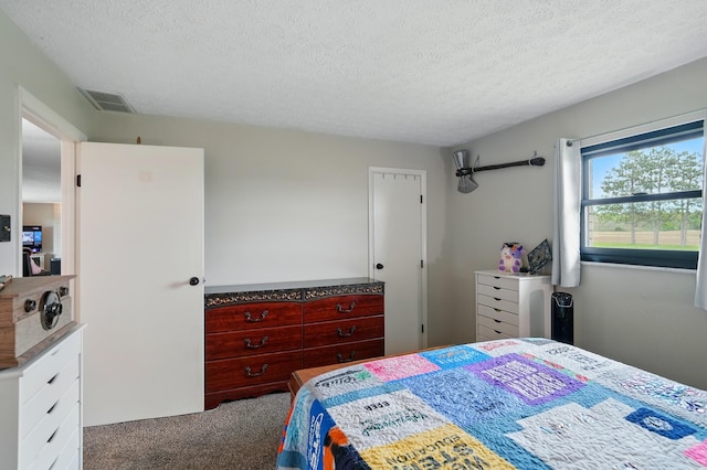 carpeted bedroom featuring visible vents and a textured ceiling