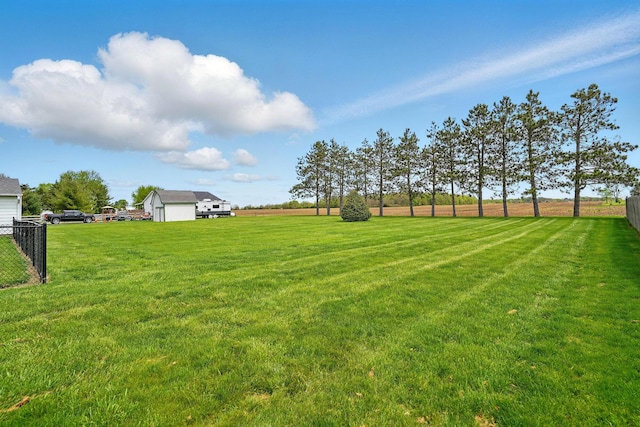 view of yard featuring fence and a rural view